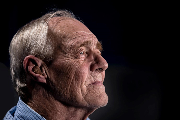 elderly man peering into the air contemplating past abuse
