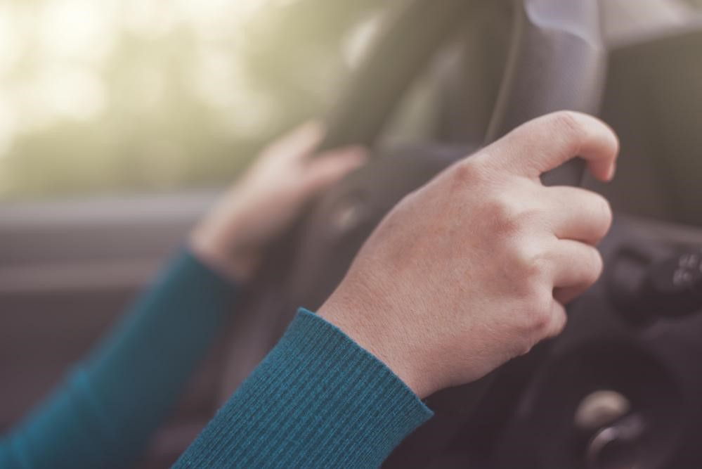 Woman driver holding steering