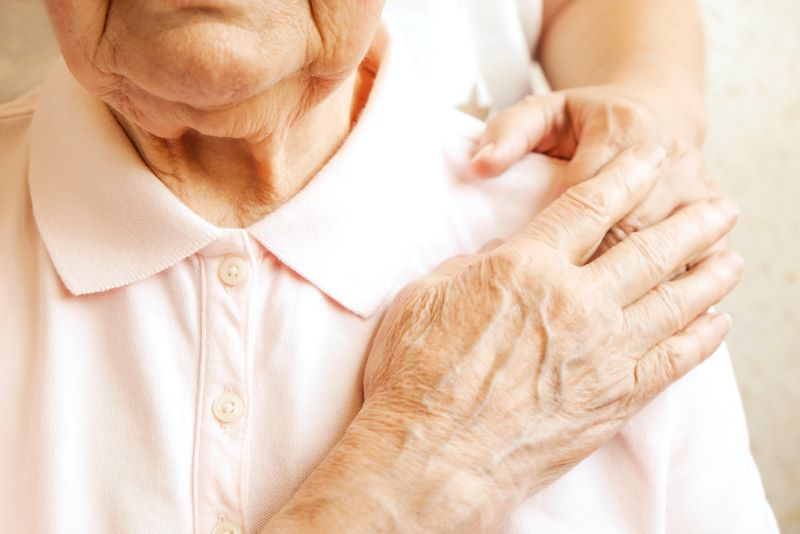 elder woman holding hand