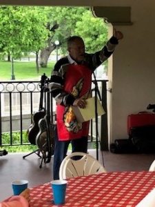 a man standing on a porch holding a clipboard