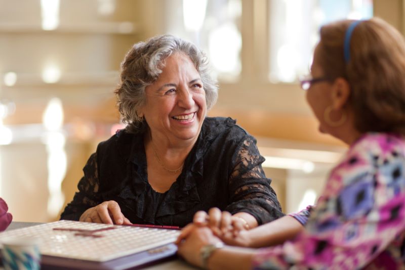 two older woman chatting in nursing home