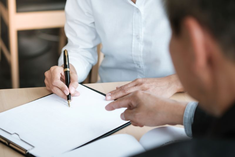 business owner singing contract with attorney